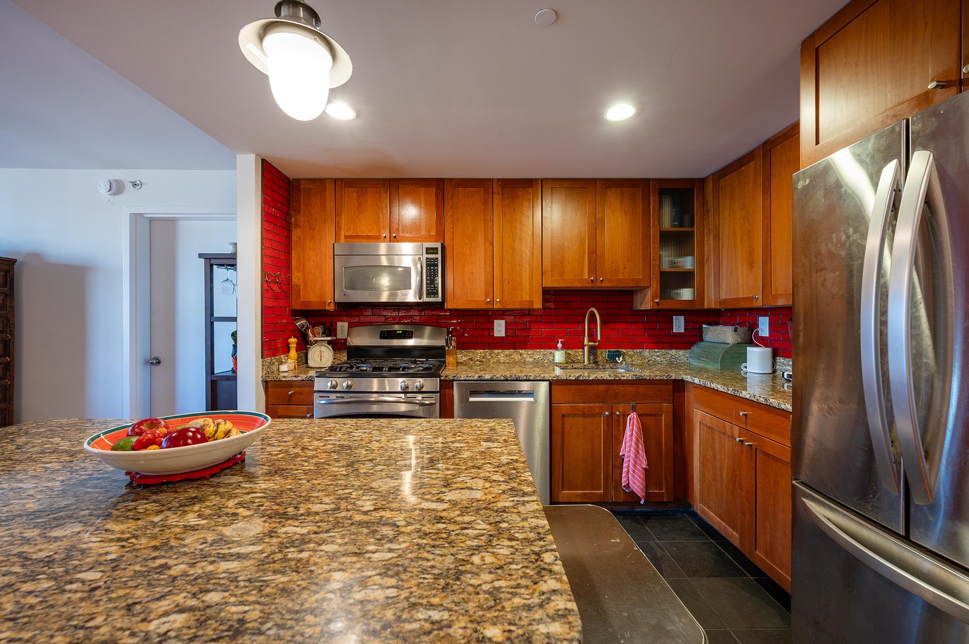 700 Grove Street, Unit 10A Jersey City, NJ 07310 - Photo 5 of 24 a kitchen with sink refrigerator and dining table