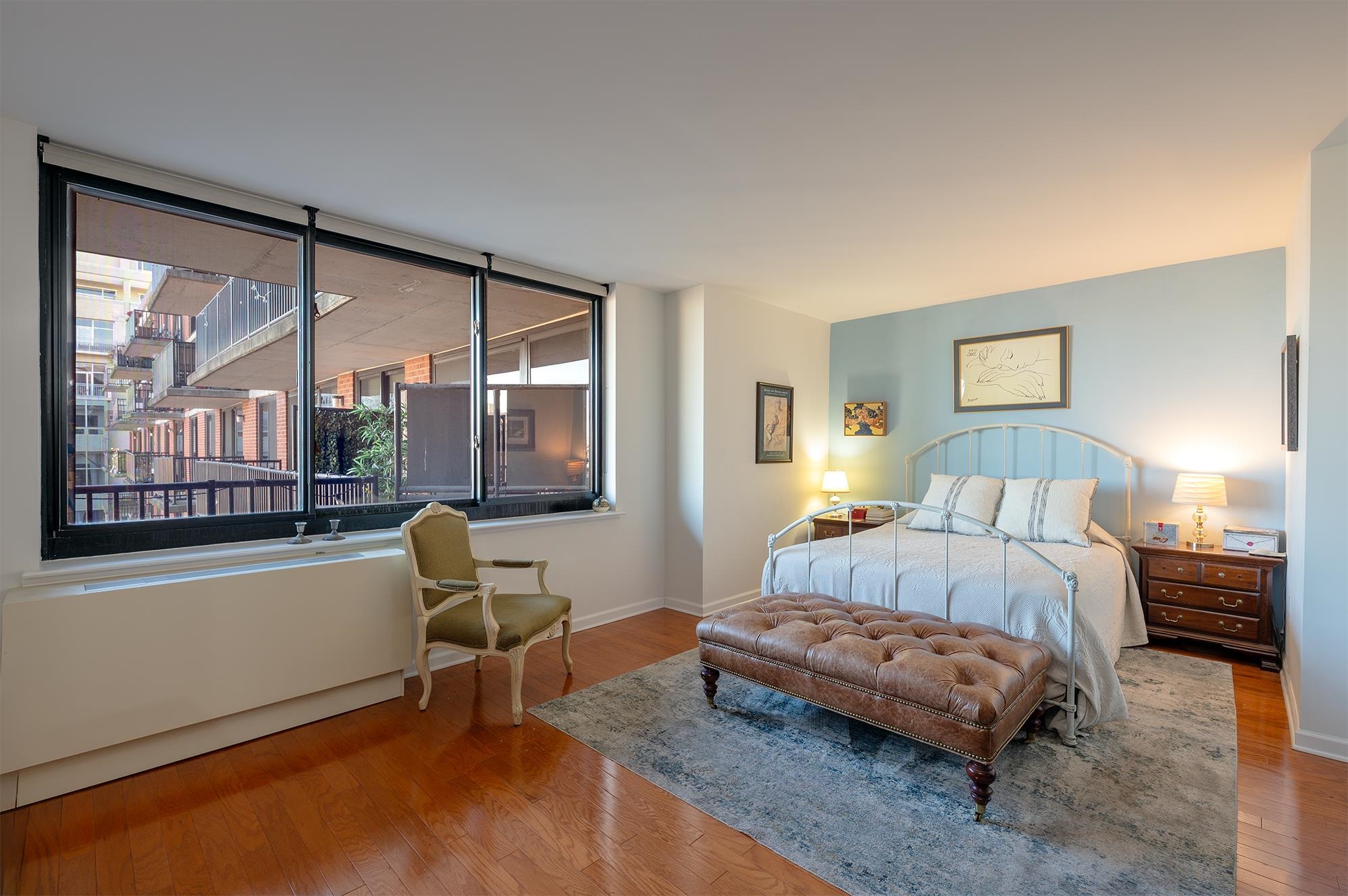 700 Grove Street, Unit 10A Jersey City, NJ 07310 - Photo 7 of 24 a bedroom with a bed and a large window