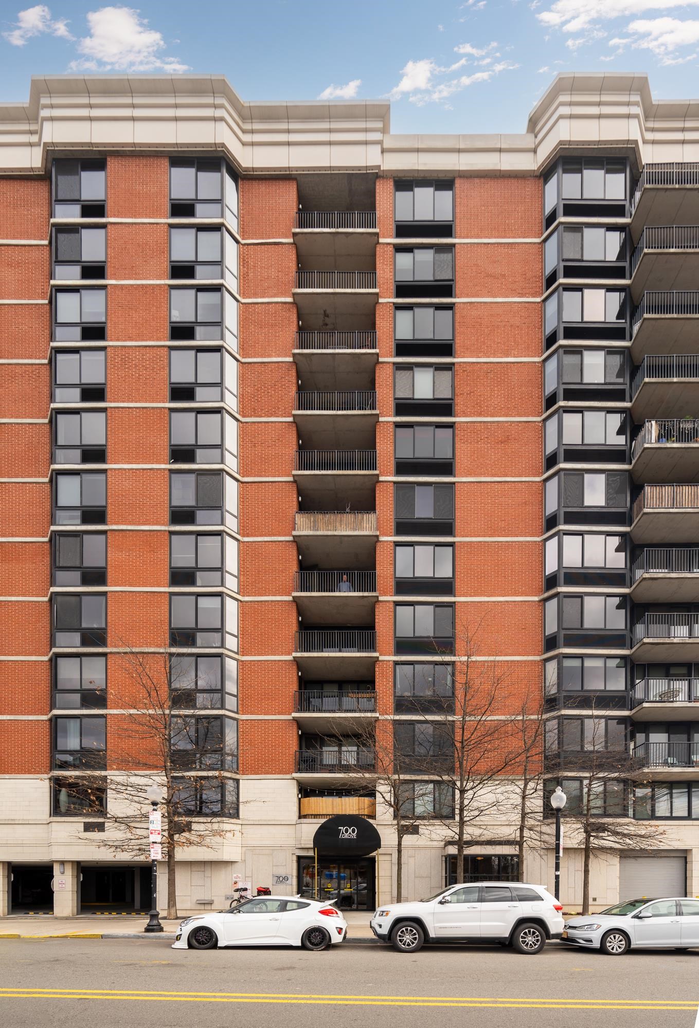700 Grove Street, Unit 10A Jersey City, NJ 07310 - Photo 9 of 24 a tall building sitting on the side of a street