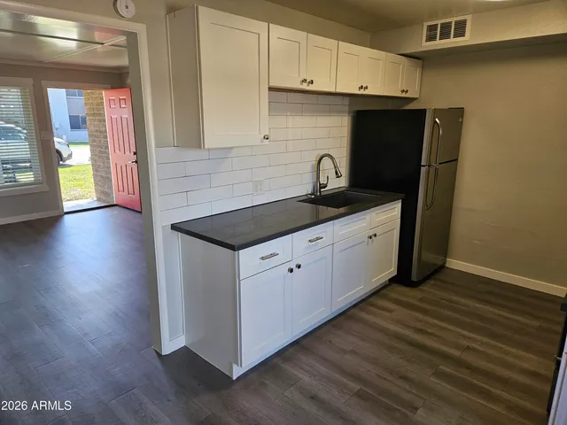 a kitchen with stainless steel appliances granite countertop a stove a sink and a refrigerator