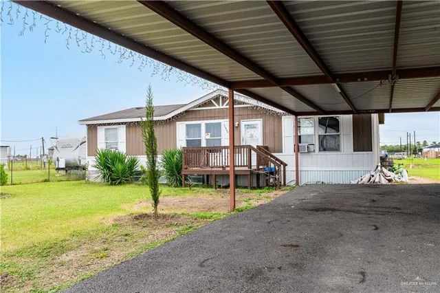 a view of a house with backyard porch and sitting area