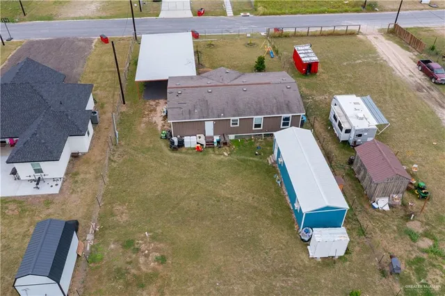 an aerial view of a house with chairs