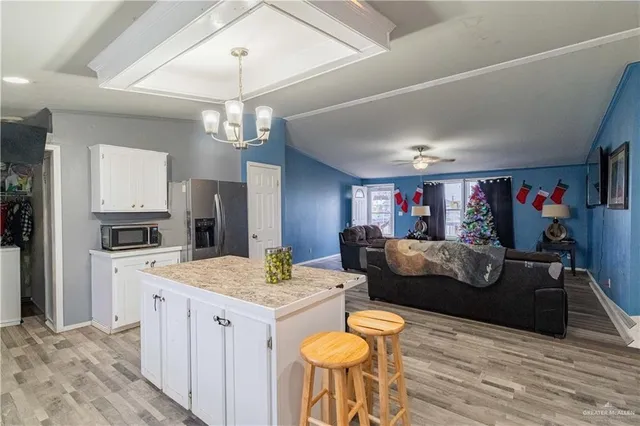 a view of a dining room with furniture and a chandelier
