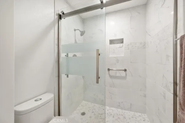 a bathroom with a shower and toilet