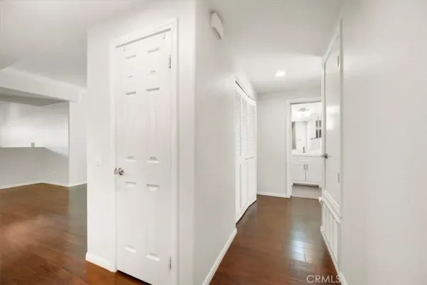 a view of a hallway with wooden floor