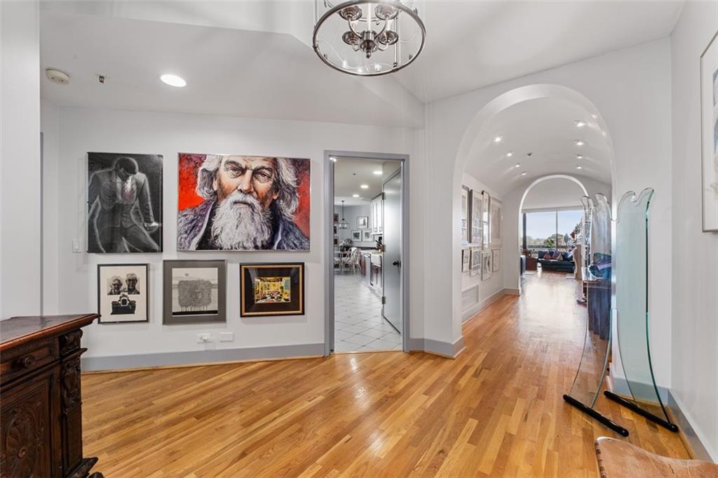 a view of a hallway with wooden floor