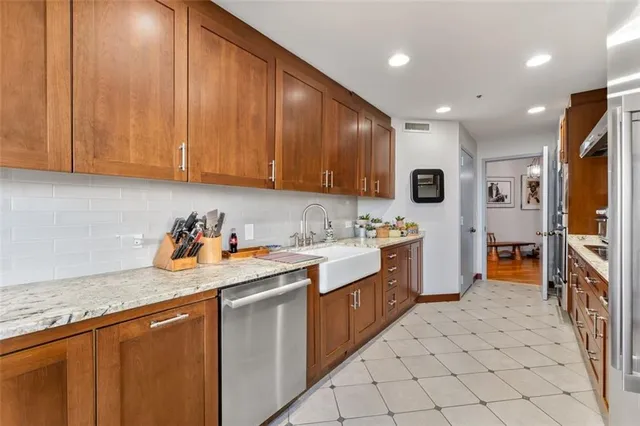 a kitchen with granite countertop a sink and cabinets