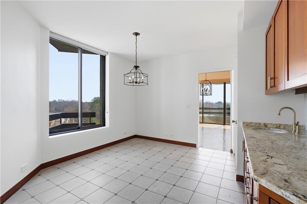2660 Peachtree Road Northwest, Unit 9G Atlanta, GA 30305 - Photo 12 of 42 a view of a kitchen with a sink cabinets and a window