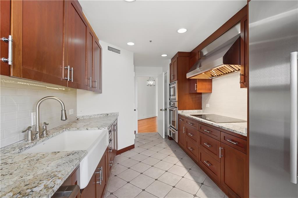 2660 Peachtree Road Northwest, Unit 9G Atlanta, GA 30305 - Photo 13 of 42 a bathroom with a granite countertop double vanity sink and mirror