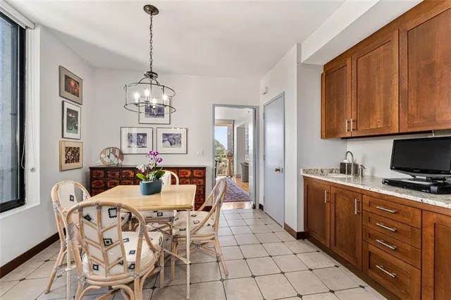 a view of a dining room with furniture and chandelier