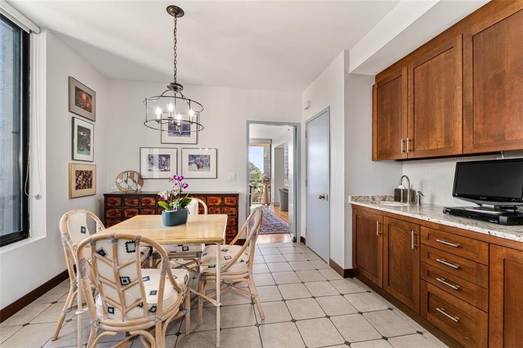 2660 Peachtree Road Northwest, Unit 9G Atlanta, GA 30305 - Photo 14 of 37 a view of a dining room with furniture and chandelier