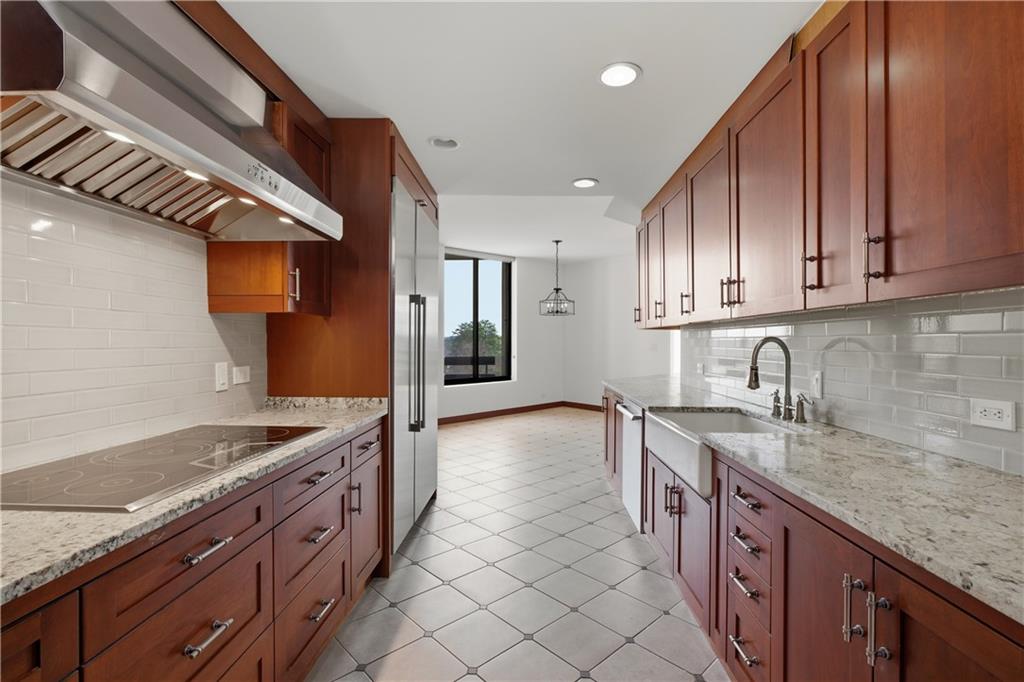 2660 Peachtree Road Northwest, Unit 9G Atlanta, GA 30305 - Photo 15 of 42 a kitchen with stainless steel appliances granite countertop a sink stove and cabinets