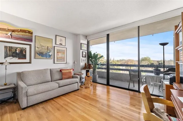 a living room with furniture city view and large windows