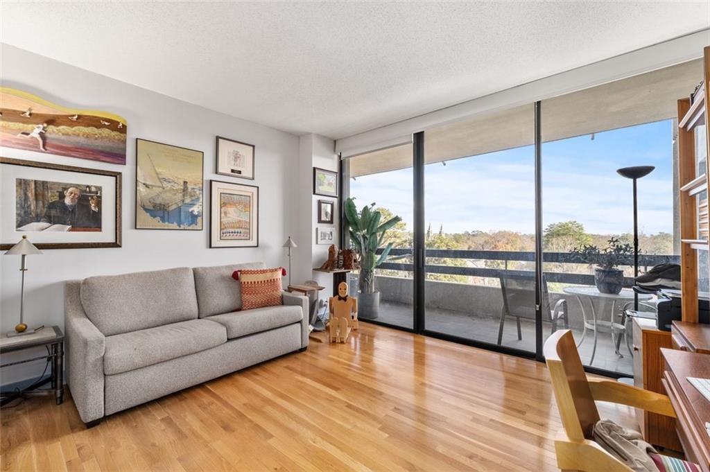 2660 Peachtree Road Northwest, Unit 9G Atlanta, GA 30305 - Photo 19 of 37 a living room with furniture city view and large windows