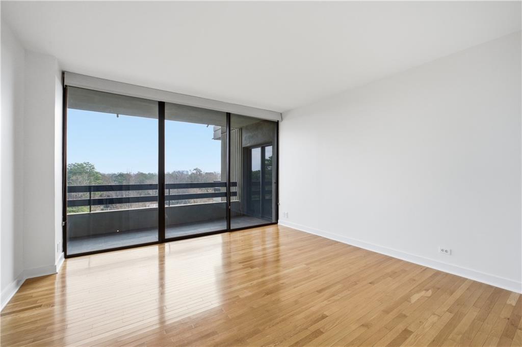 2660 Peachtree Road Northwest, Unit 9G Atlanta, GA 30305 - Photo 20 of 42 wooden floor in an empty room with a window