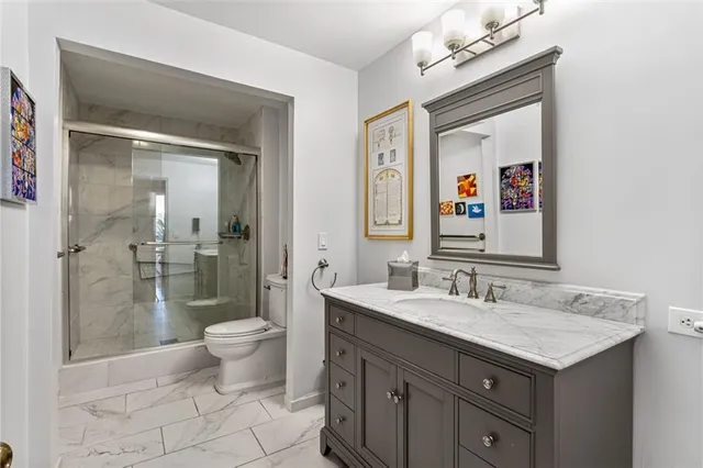 a bathroom with a toilet sink and mirror