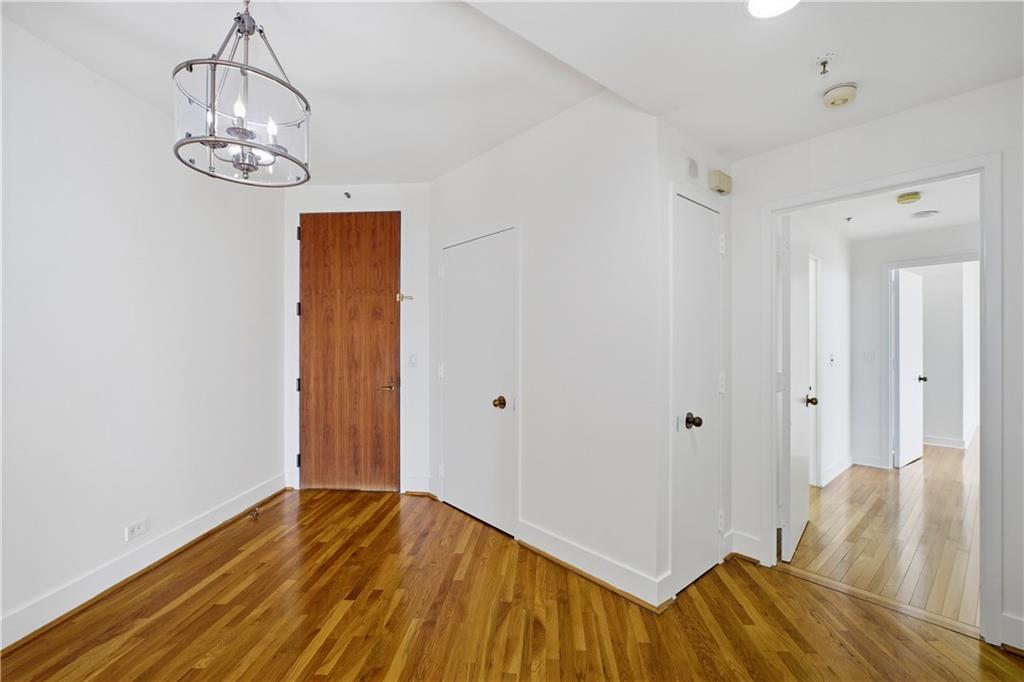 2660 Peachtree Road Northwest, Unit 9G Atlanta, GA 30305 - Photo 2 of 42 a view of a livingroom with wooden floor and chandelier
