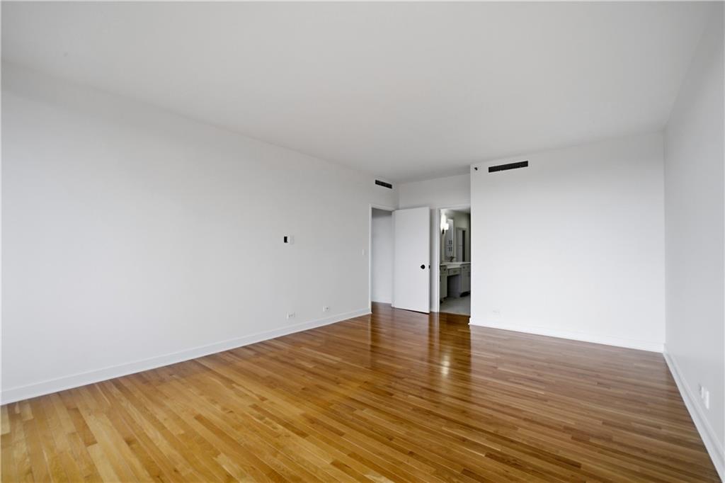2660 Peachtree Road Northwest, Unit 9G Atlanta, GA 30305 - Photo 22 of 42 a view of an empty room with wooden floor