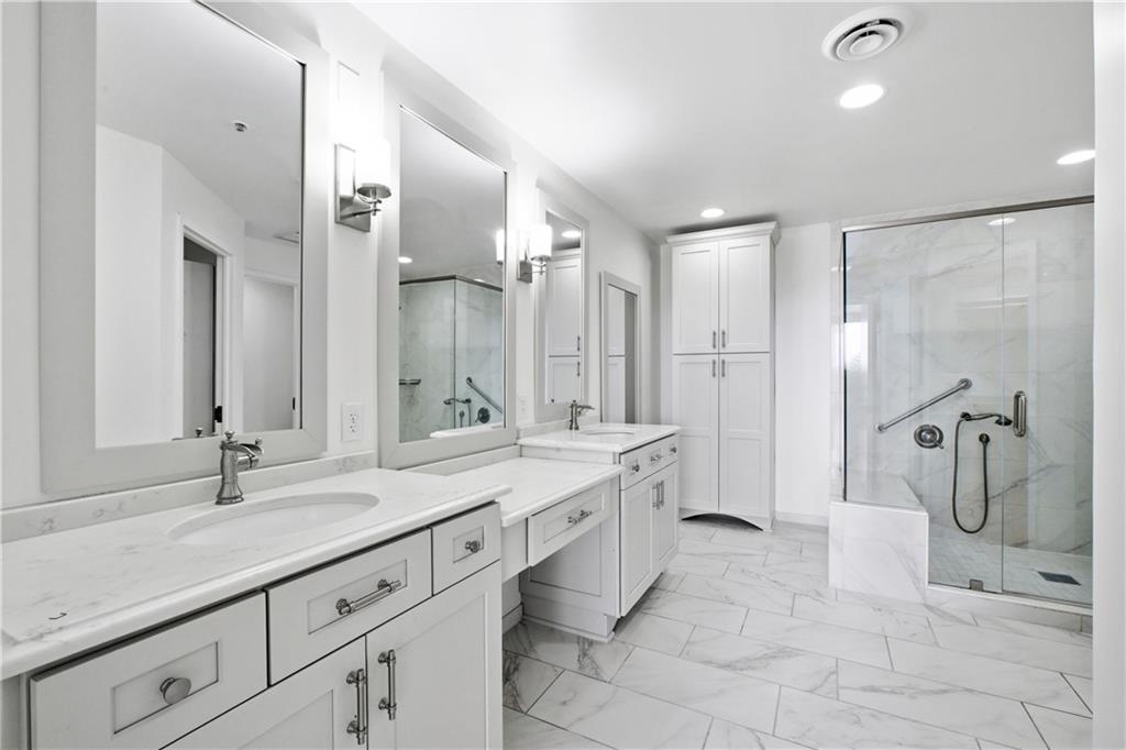 2660 Peachtree Road Northwest, Unit 9G Atlanta, GA 30305 - Photo 23 of 42 a spacious bathroom with a double vanity sink mirror double and shower