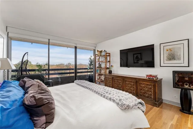 a bed room with a bed and a flat tv screen on a dresser