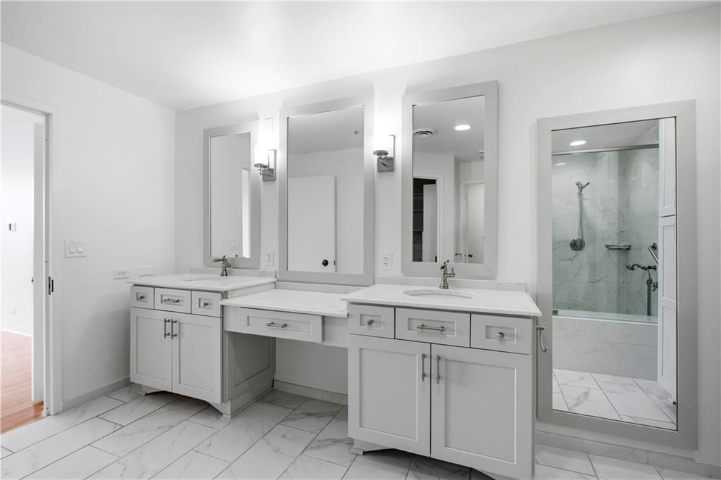 2660 Peachtree Road Northwest, Unit 9G Atlanta, GA 30305 - Photo 25 of 42 a bathroom with a sink and a mirror