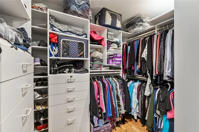 a view of walk in closet with clothes