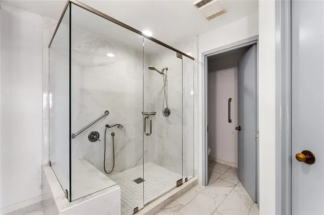 a bathroom that has a glass shower door