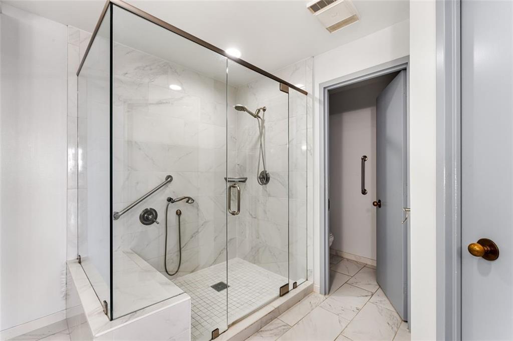 2660 Peachtree Road Northwest, Unit 9G Atlanta, GA 30305 - Photo 27 of 37 a bathroom that has a glass shower door