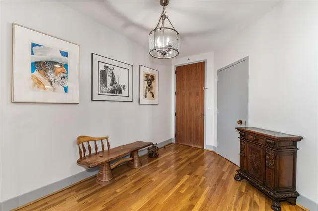 a spacious bedroom with a bed and a chandelier
