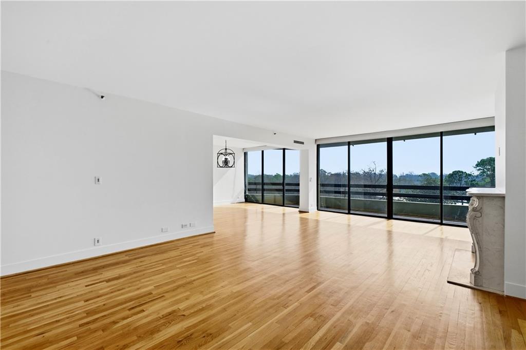 2660 Peachtree Road Northwest, Unit 9G Atlanta, GA 30305 - Photo 3 of 42 a view of an empty room with wooden floor and a window