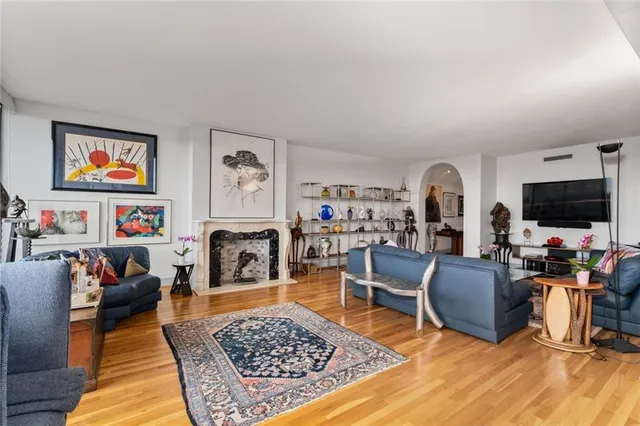 a living room with furniture and a fireplace
