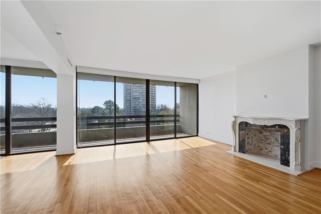 2660 Peachtree Road Northwest, Unit 9G Atlanta, GA 30305 - Photo 8 of 42 a view of an empty room with wooden floor and a window