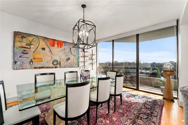 a dining room with furniture a chandelier and wooden floor