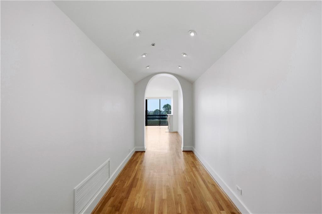 2660 Peachtree Road Northwest, Unit 9G Atlanta, GA 30305 - Photo 9 of 42 a view of a hallway with wooden floor