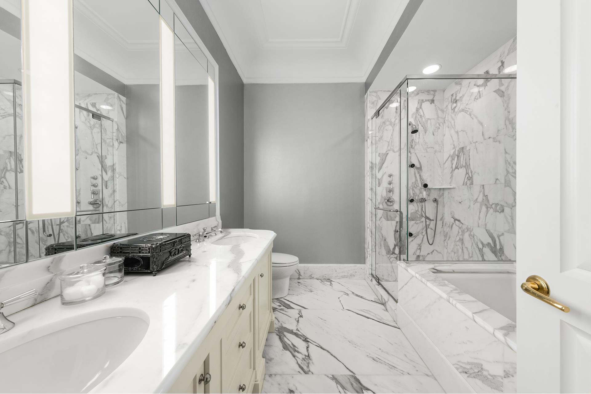 15 Central Park West, Unit 6K Manhattan, NY 10023 - Photo 5 of 13 a bathroom with a granite countertop tub sink and a shower