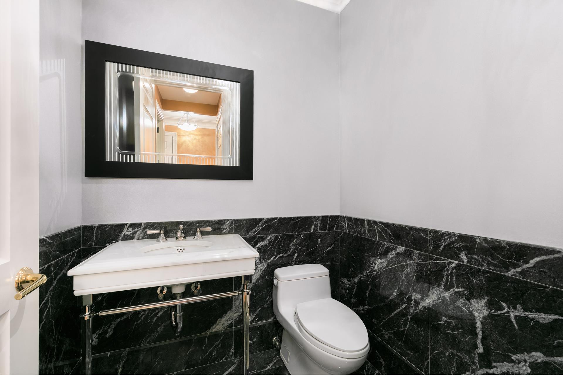 15 Central Park West, Unit 6K Manhattan, NY 10023 - Photo 6 of 13 a bathroom with a toilet a sink and a mirror