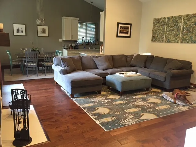 a living room with furniture a rug and a table