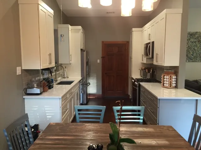 a kitchen with sink cabinets and stove