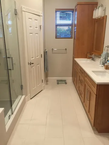 a bathroom with a sink a mirror and a shower