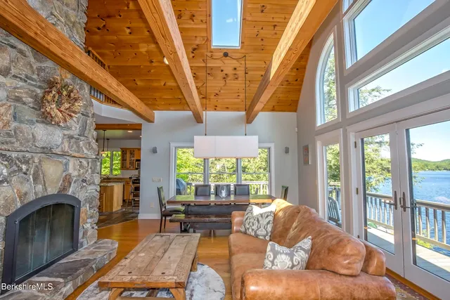 a living room with furniture a fireplace and a table