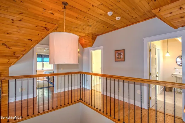 a bedroom with double bed and a chandelier