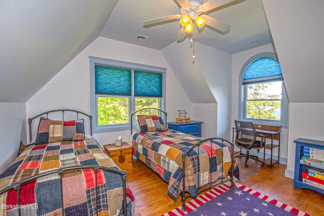 a bedroom with a bed and a television