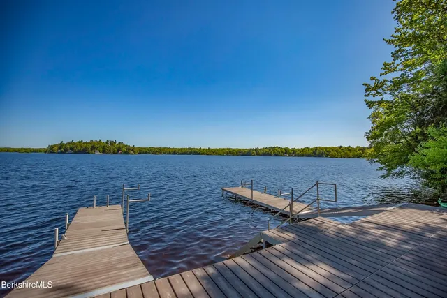 a view of lake with sunset in background
