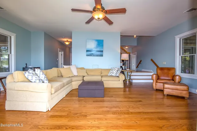 a bedroom with a bed next to a window