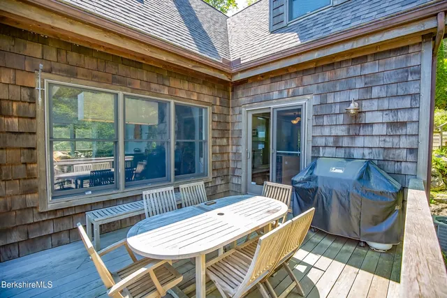 a view of a balcony with wooden floor and outdoor seating