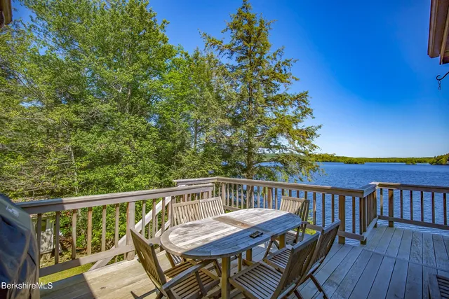 a view of balcony with wooden floor and fence and lake view