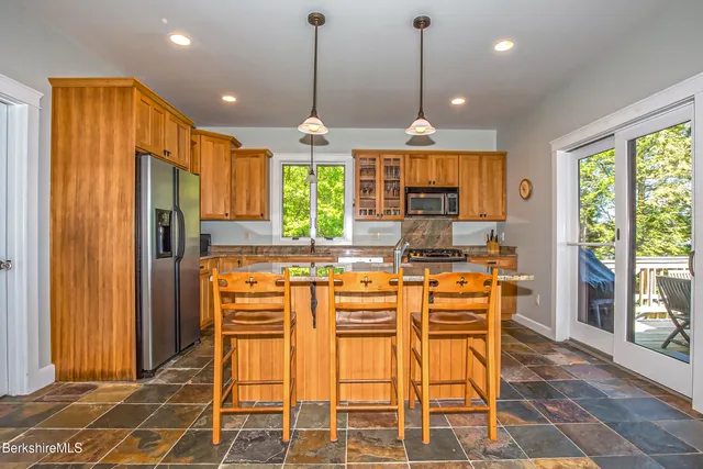 a bathroom with a sink a mirror and a shower