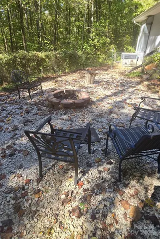 a view of a yard with wooden fence