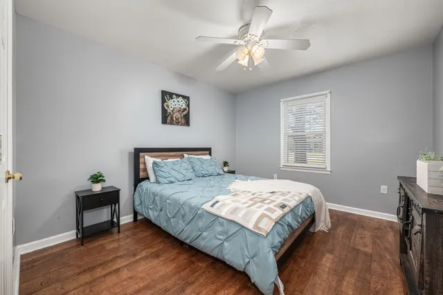 a bedroom with a bed and a ceiling fan