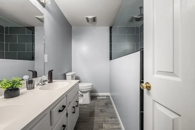 a bathroom with a sink toilet and shower